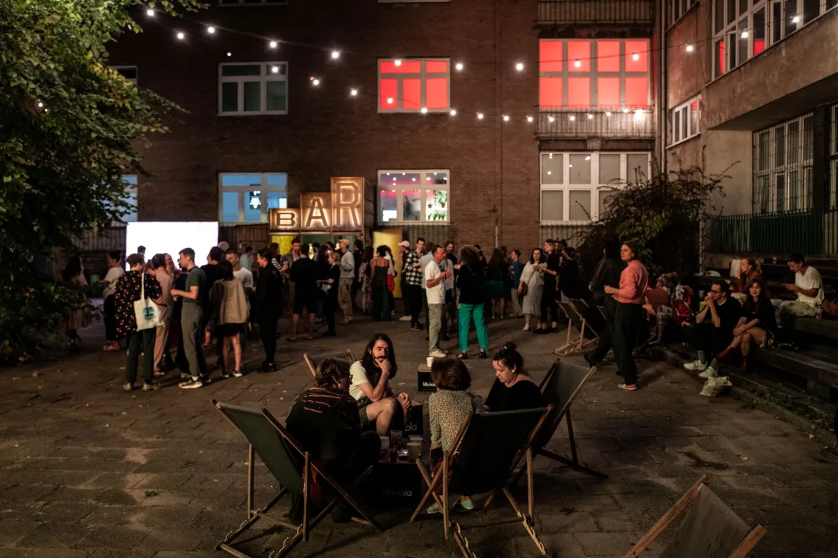 ludzie na dziedzińcu po zmroku podczas festiwalu