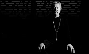 czarno-białe zdjęcie mężczyzny pozującego na siedząco