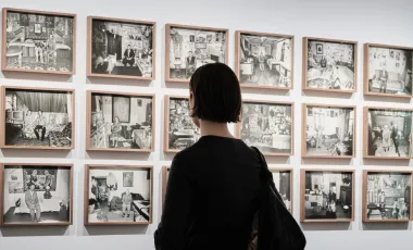 kobieta ogląda zdjęcia na ścianie