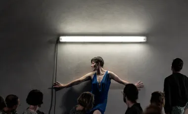 Performerka opierająca się o ścianę